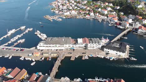 Aerial:-sea-side-hill-island-city-with-port-at-Kragero,-Norway---drone-tilt-up-shot