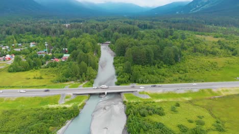 4K-Cinematic-Drone-Video-of-Seward-Highway-Alaska-Route-1-over-Glacier-Creek-with-Girdwood,-AK-in-Background