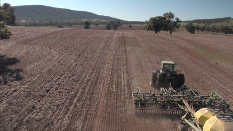 Aerial-view-of-Tractor-towing-Air-Seeder-coming-into-view-in-a-large-paddock-in-the-rural-town-of-Yerong-Creek-Wagga-Wagga-NSW-Australia