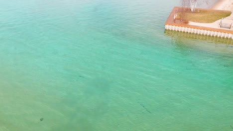 Aerial-footage-of-Crystal-clear-blue-waters-of-Torch-Lake-in-Michigan