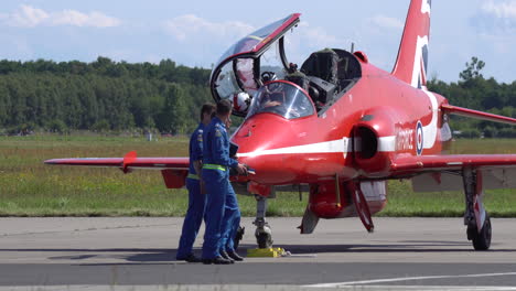Airplane-mechanics-in-blue-uniforms-performing-preflight-inspection