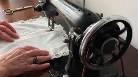 Hands-of-a-woman-sewing-on-an-antique-Sigma-sewing-machine