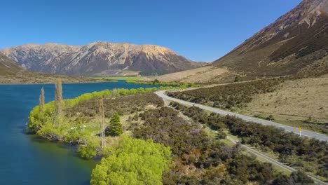 Aerial-view-of-road-along-lake-Pearson-in-Canterbury,-New-Zealand