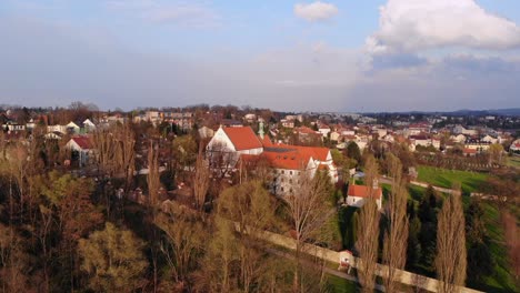 White-walls-of-Saint-Francis-Monastery-on-hill-aerial-view,-Wieliczka,-Poland