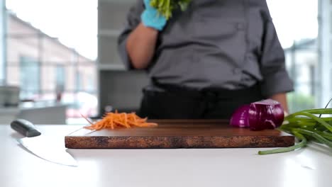 Chef-places-parsley-onto-cutting-board-in-slow-motion