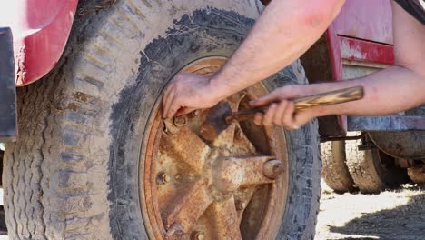 Knocking-a-rusted-wedge-block-loose-on-a-rusty-Dayton-rim-in-order-to-change-wheels