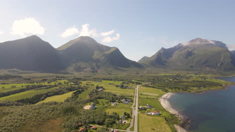 Aerial-shot-of-a-mountain-valley-and-farmland-on-the-coast-of-Norway