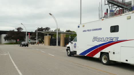 Area-field-command-van-of-Toronto-police-driving-in-street,-handheld-view