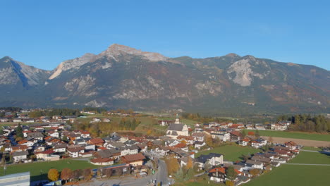 Soothing-morning-flyover-towards-Church-in-Tirol,-Austria,-drone-forward-shot