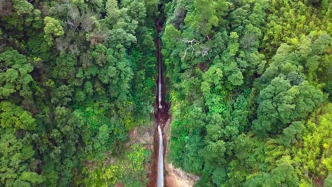 Aerial-4K-footage-of-a-huge-waterfall-in-a-jungle-environment-in-Sao-Miguel,-Azores