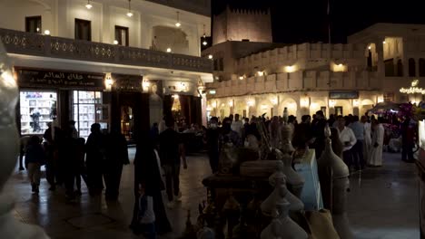 Nighttime-at-the-central-souk-in-Doha,-Qatar-with-tourists-and-locals-shopping