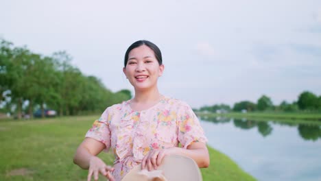 Beautiful-Asian-woman-making-video-call-and-smiling-and-waving-greetings