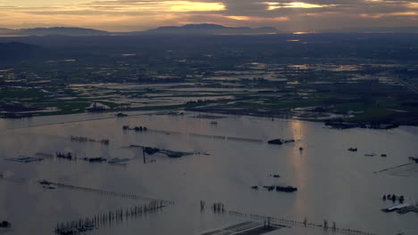 Sunset-Landscape-with-Flooded-Farm-Fields-and-Buildings,-BC,-Aerial