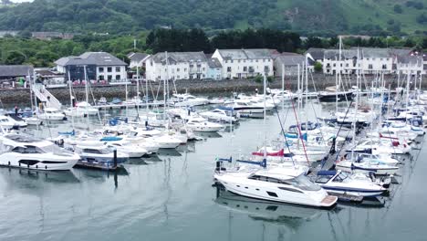 Luxury-yachts-and-sailboats-parked-on-misty-mountain-range-retirement-village-marina-dolly-closeup-left