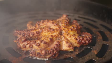 Cinematic-close-up-shot-of-golden-brown-char-grilled-smoky-flavor-octopus-on-piping-hot-grill
