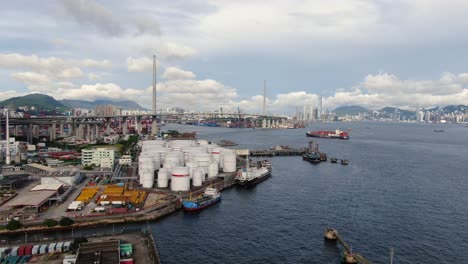 Hong-Kong-commercial-Port,-aerial-approach-passing-above-Oil-and-Chemical-storage-depot