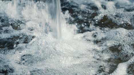 water-falling-with-foam,-close-up,-slow-motion