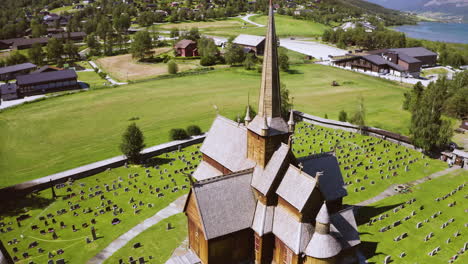 Bird's-Eye-View-Of-Lom-Stave-Church-Surrounded-With-Tombstones-At-Daytime-In-Norway