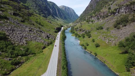 Exuberante-Valle-De-Montaña-Entre-Klagegg-Y-Byrkjelo-Con-La-Carretera-E39-Pasando---Río-Stardalselva-Con-Color-Verde-Fluyendo-Al-Lado-De-La-Carretera---Stardalen-Sogn-Noruega