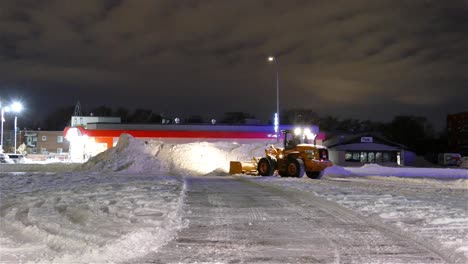 Bulldozer-Cleans-the-Street-of-snow-at-the-City-of-Montreal-at-Night-in-Winter