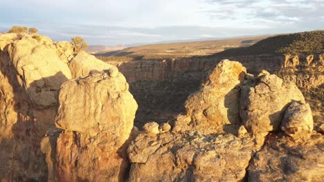 Aerial-view-of-Colorado-butte-at-sunset-with-drone-video-going-near-rocks