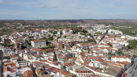 Historic-City-Of-Silves-And-The-Medieval-Castle-In-Algarve,-Portugal---aerial-drone-shot