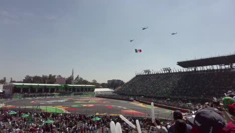 Three-Helicopters-flying-over-the-the-Grandstand-Foro-Sol-Auditorium-at-the-F1-GP-Grand-Prix-in-Mexico-City-circuit-carrying-the-Mexican-Flag