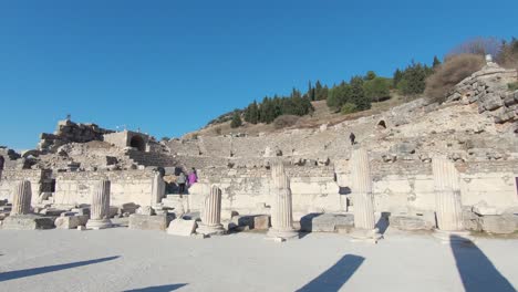 People-visiting-ruins-of-Ephesus-Theatre,-Unesco-world-heritage-site
