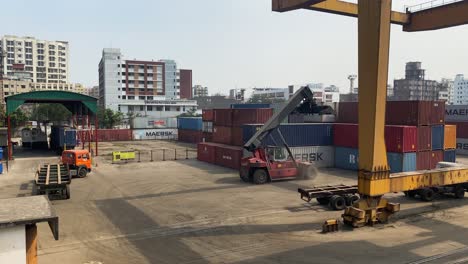 Crane-loading-heavy-MAERSK-containers-at-Dhaka-inland-container-depot,-Bangladesh