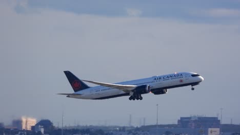 Air-Canada-airlines-airplane-take-off,-pan-shot,-cloudy-sky