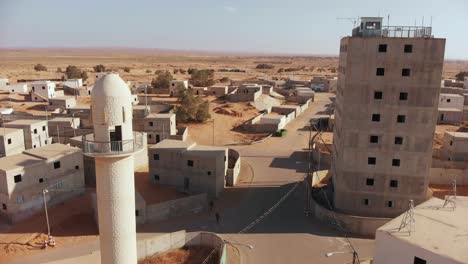 aerial-shot-of-mosque-in-the-foreground-next-to-a-big-old-building-at-palestine-near-gaza-in-the-desert
