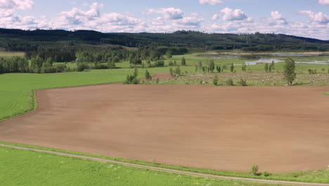 2-MONTH-AERIAL-TIMELAPSE-FRONT-WIPE-of-crops-growing-from-a-ploughed-field