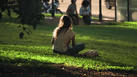 Woman-enjoying-reading-a-book-in-Las-Heras-Park,-Buenos-Aires