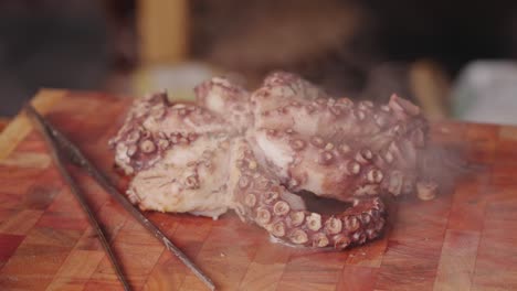 Cinematic-handheld-shot-around-a-smoking-hot-half-cooked-boiled-fresh-pacific-octopus-with-vaporized-steams-in-the-scene
