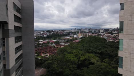 Drone-shot-flying-between-buildings-in-the-city-of-San-Jose,-Costa-Rica