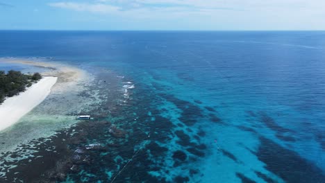 High-view-across-a-underwater-reef-system-towards-a-group-of-boats-moored-in-the-tropical-blue-Island-waters