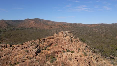 Pullback-from-Adventurer-man,-revealing-majestic-remote-landscape,-Flinders-Range-National-Park,-Australia