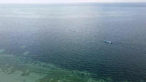 Una-Lancha-Timorense-Tradicional-Local-De-Pesca-Y-Transporte-Que-Viaja-Sobre-Los-Arrecifes-De-Coral-En-La-Isla-De-Atauro,-Timor-Leste,-Sudeste-De-Asia