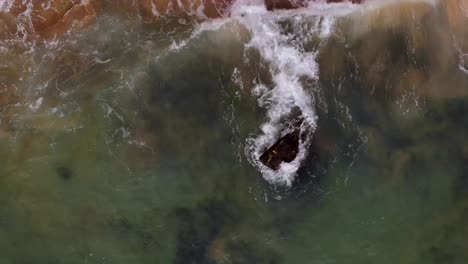 Waves-Crashing-onto-Rocky-Shore-of-Port-of-Portimao---Aerial