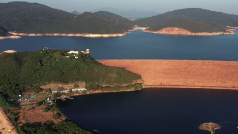 Aerial-view-over-Sai-Kung,a-back-garden-of-Hong-Kong-with-fishing-villages,-beautiful-scenery,-hiking-trails,-beaches-and-islands-and-geological-formations-on-a-bright-sunny-day