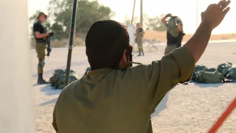 An-ultra-Orthodox-religious-soldier-with-a-cigarette-in-his-hand-dances-as-soldiers-prepare-for-fighting-with-equipment
