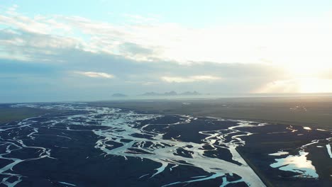 Scenic-tributary-stream-river,-natural-estuary-landscape,-aerial-view-of-Iceland