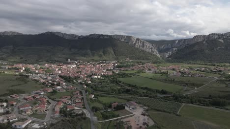 Fly-low-over-small-town-in-lush-French-Pyrenees-Orientales-region