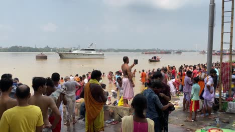 Babu-Ghat,-Kolkata-:-Group-of-Hindu-devotees-to-take-part-in-the-"Tarpan"-rituals,-standing-in-Ganges-water
