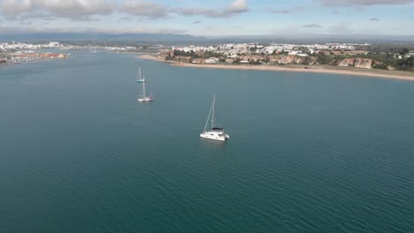 Sailboat-Yachts-in-Mediterranean-Sea-off-Portimao-Coast-in-Portugal,-Aerial