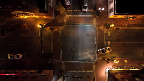 Top-down-rising-aerial-of-car-in-intersection