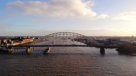 Aerial-View-Of-Brug-Over-De-Noord-With-Traffic-And-Barges-Approaching-On-Sunny-Afternoon