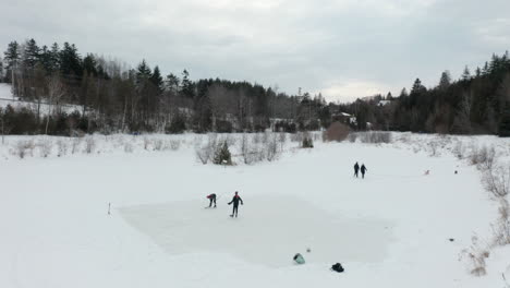 Aerial-view-of-people-playing-hockey-on-a-frozen-pond
