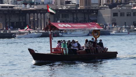 Tourist-people-wearing-face-mask-on-an-Abra-water-taxi-on-Khawr-Dubayy,-Old-town