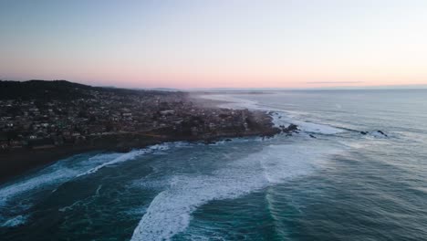 Aerial-hyperlapse-of-a-sunset-on-the-beach-of-pichilemu-with-waves-crashing-against-the-shore